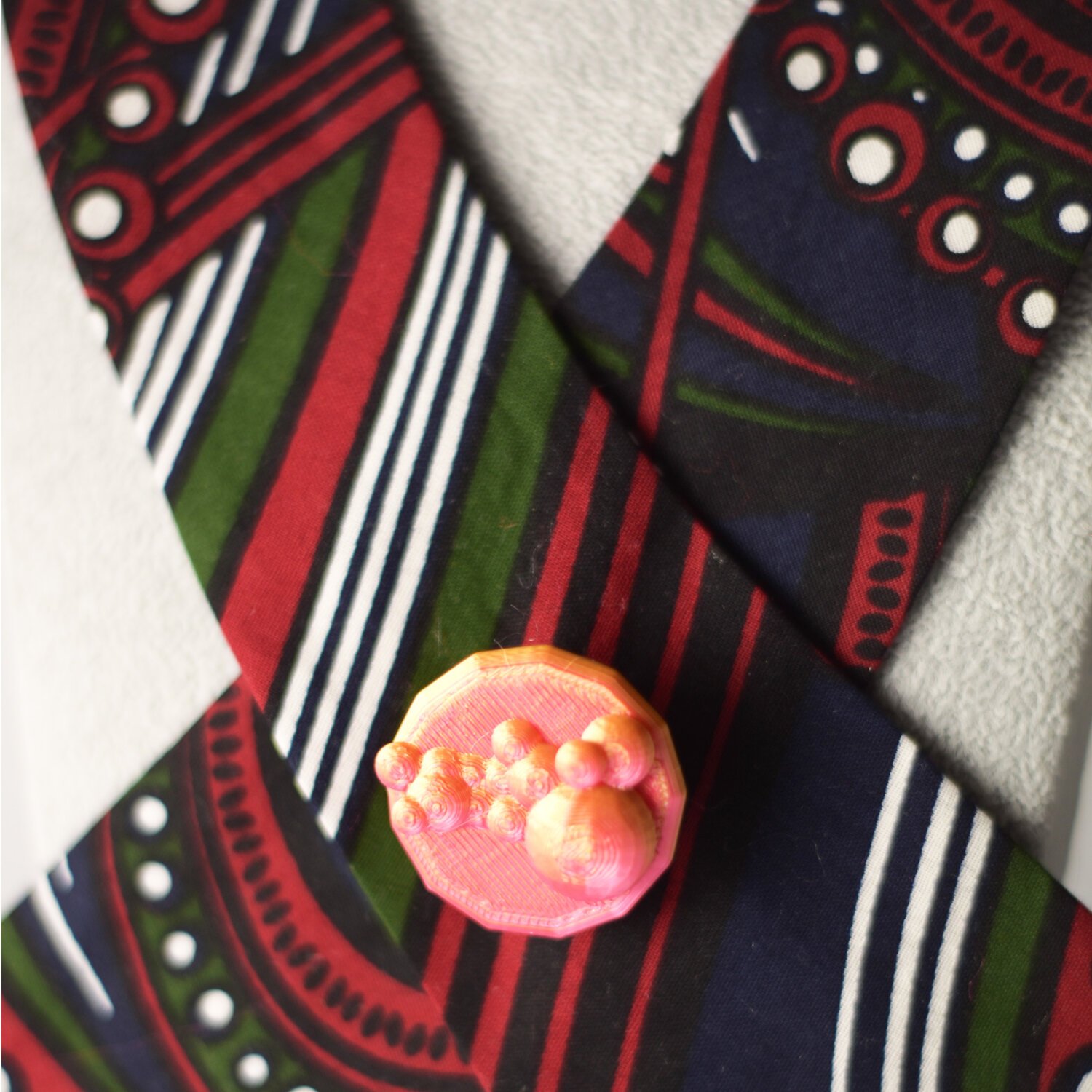 Fuchsia cup button cover close-up on patterned fabric